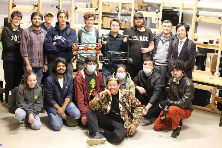 TARS Lab group photo with modular box drone and quadcopter prototypes; researchers and students in the lab.